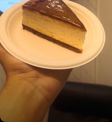 Slice of baked cheesecake with a chocolate top