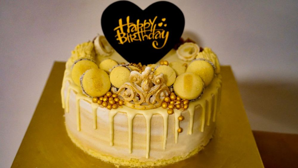 Golden birthday cake with heart topper